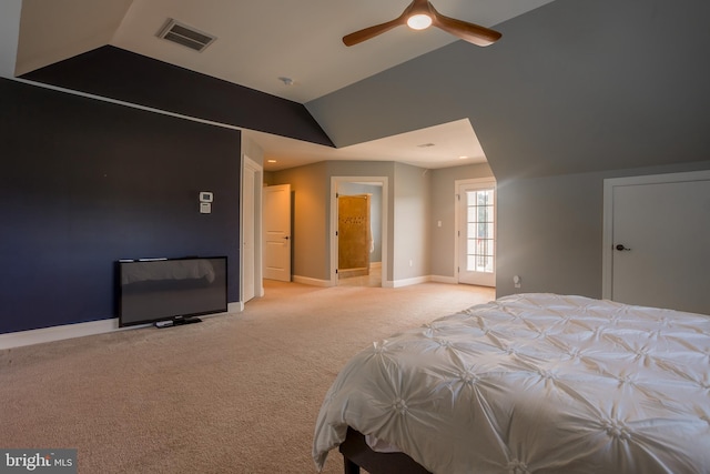 unfurnished bedroom with lofted ceiling, connected bathroom, light colored carpet, and ceiling fan