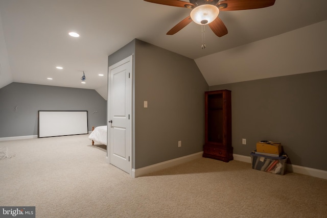 bonus room featuring light carpet, ceiling fan, and vaulted ceiling