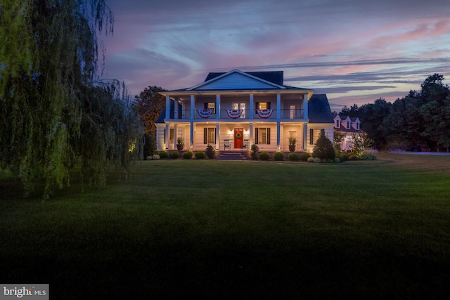 neoclassical home featuring a lawn