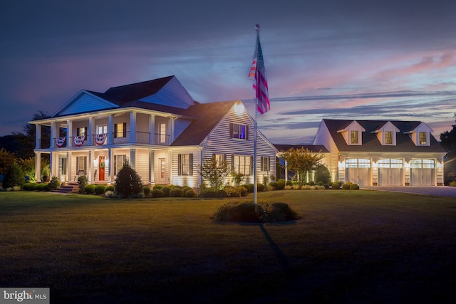 view of front of house featuring a garage and a yard