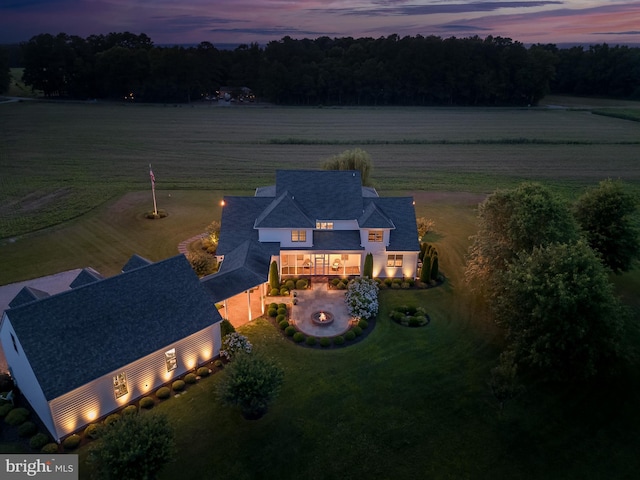 aerial view at dusk featuring a rural view