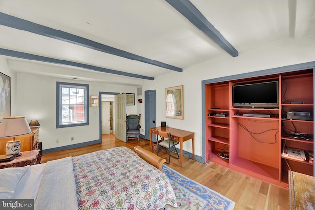 bedroom with beamed ceiling, visible vents, baseboards, and wood finished floors