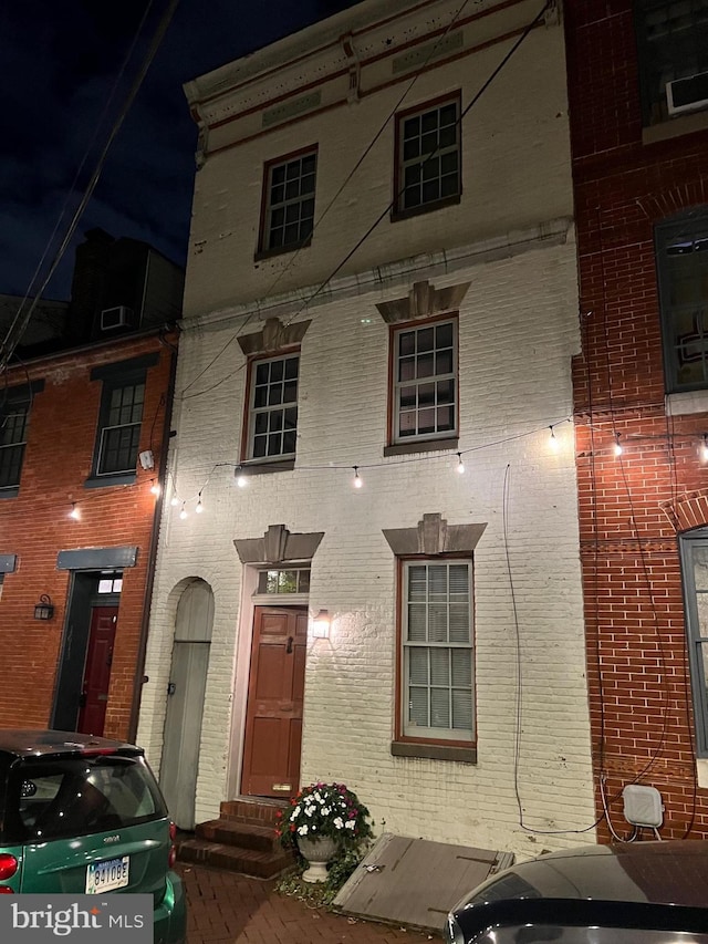 view of front of house featuring brick siding and entry steps