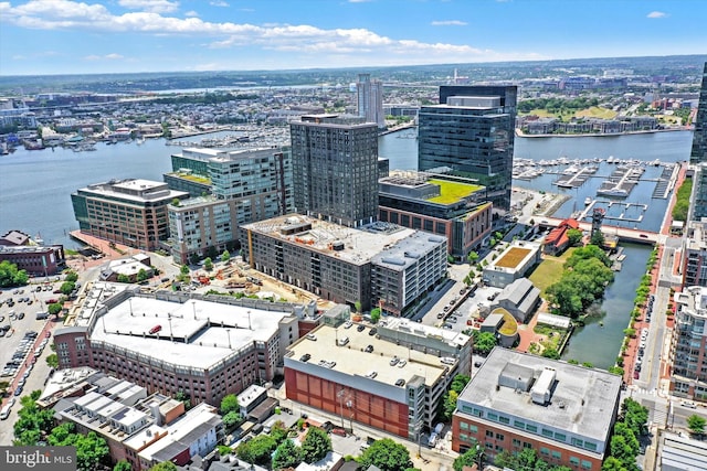 birds eye view of property with a city view and a water view