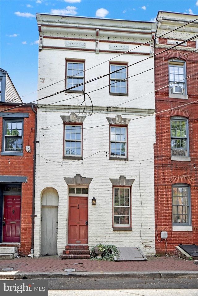 view of property featuring brick siding and entry steps