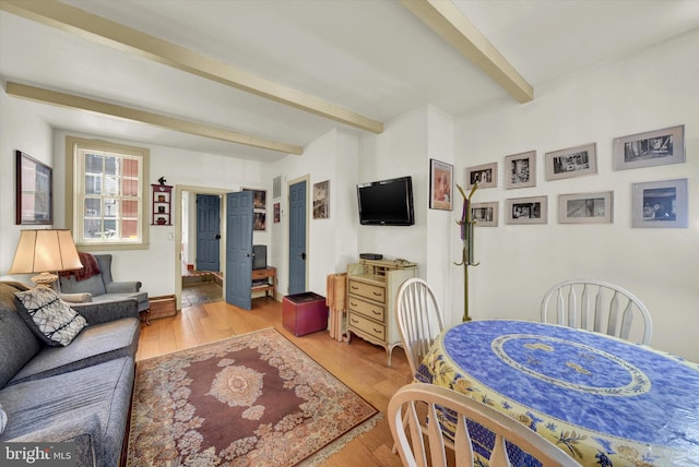 bedroom featuring beamed ceiling and hardwood / wood-style flooring