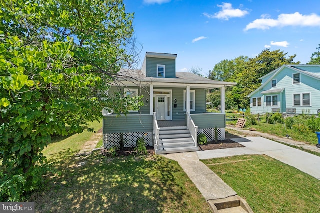 bungalow with covered porch and a front yard