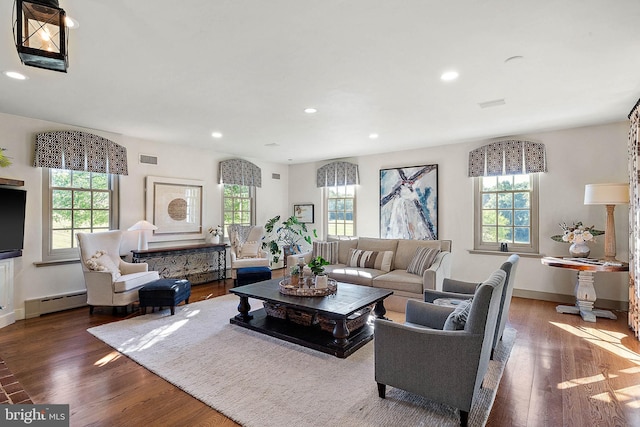 living room with dark hardwood / wood-style floors and baseboard heating