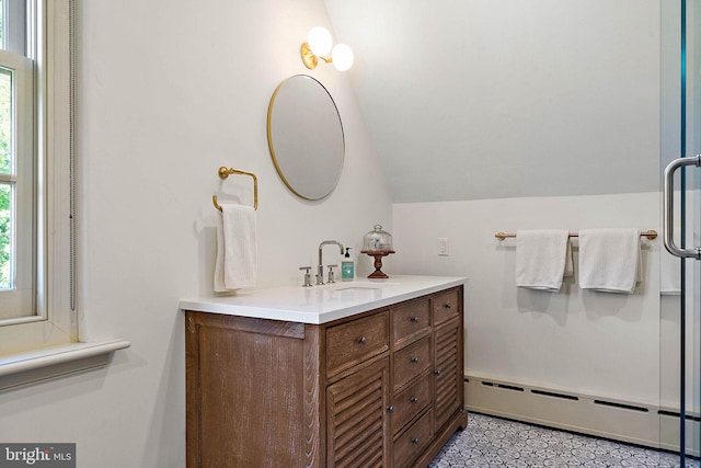 bathroom with vanity, lofted ceiling, and a baseboard heating unit