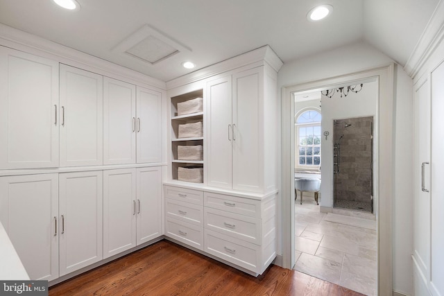 walk in closet featuring lofted ceiling