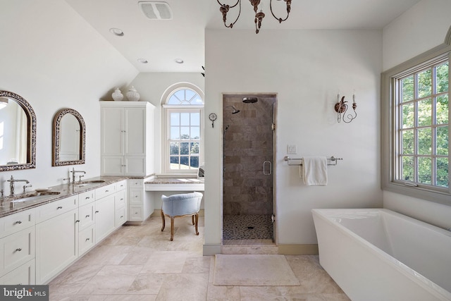 bathroom with lofted ceiling, vanity, a notable chandelier, and shower with separate bathtub