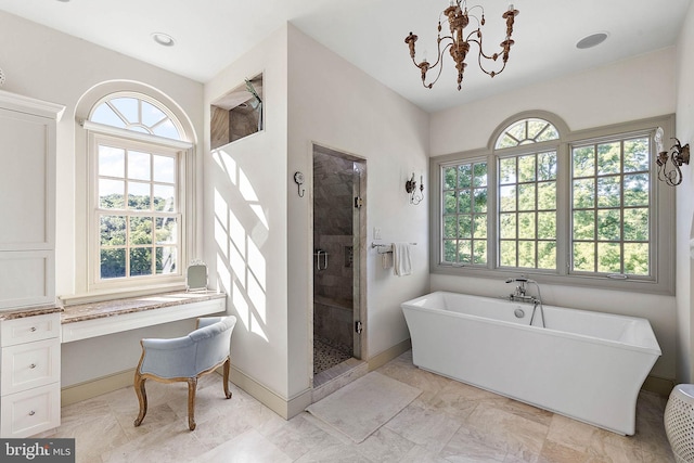 bathroom featuring separate shower and tub and an inviting chandelier