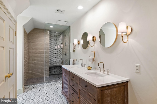 bathroom featuring tile patterned floors, vanity, and tiled shower