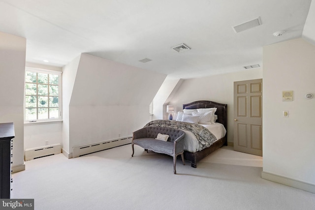 bedroom featuring vaulted ceiling, light carpet, and a baseboard heating unit