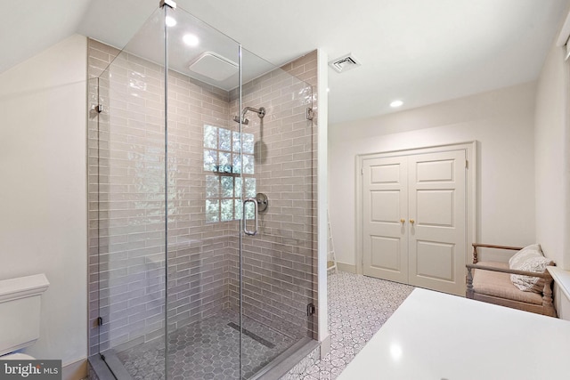 bathroom featuring toilet and walk in shower