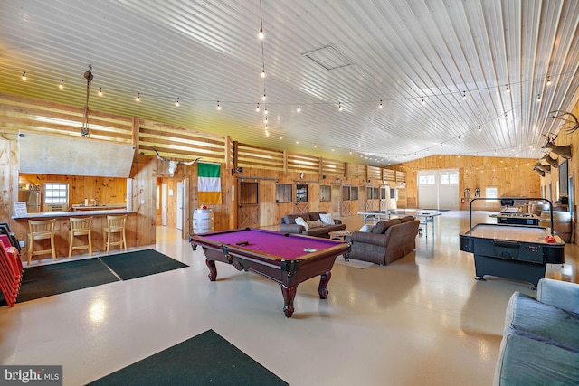 playroom featuring wood walls, concrete flooring, and billiards