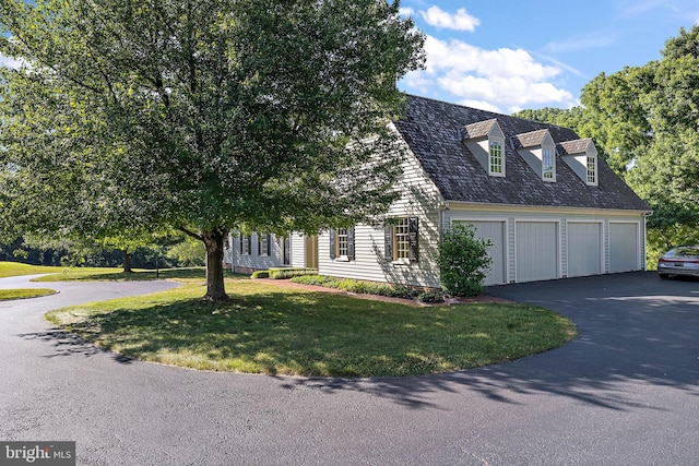 view of front of house with a garage and a front lawn