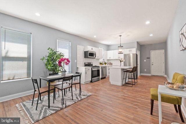 dining area with light wood-type flooring