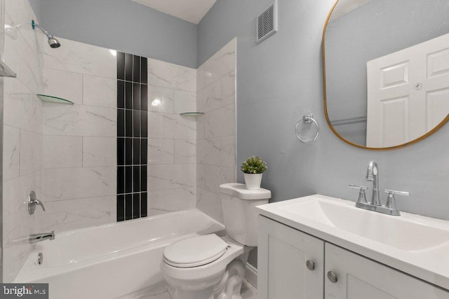 full bathroom with vanity, tiled shower / bath combo, and toilet