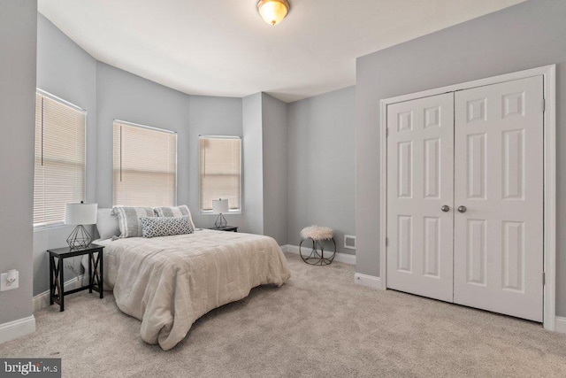 carpeted bedroom with a closet