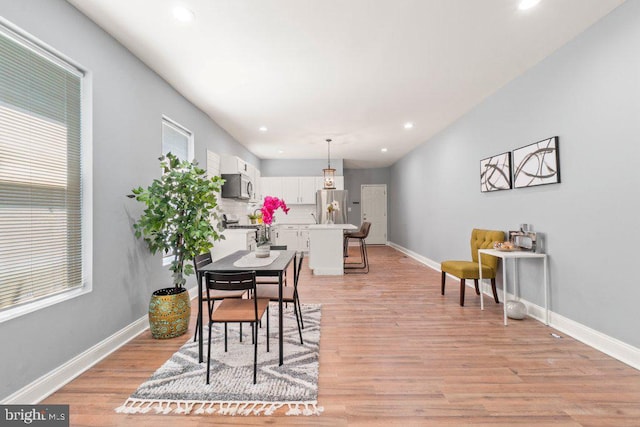 dining area featuring light wood-type flooring