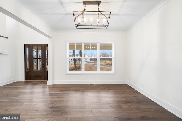 entrance foyer with dark hardwood / wood-style floors, crown molding, and a notable chandelier