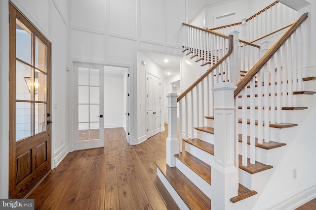 entryway featuring hardwood / wood-style flooring and french doors