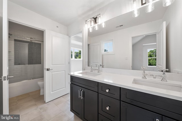 full bathroom with shower / bath combination with glass door, vanity, toilet, and plenty of natural light