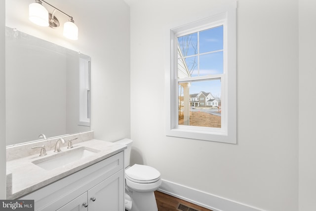 bathroom featuring hardwood / wood-style floors, vanity, and toilet