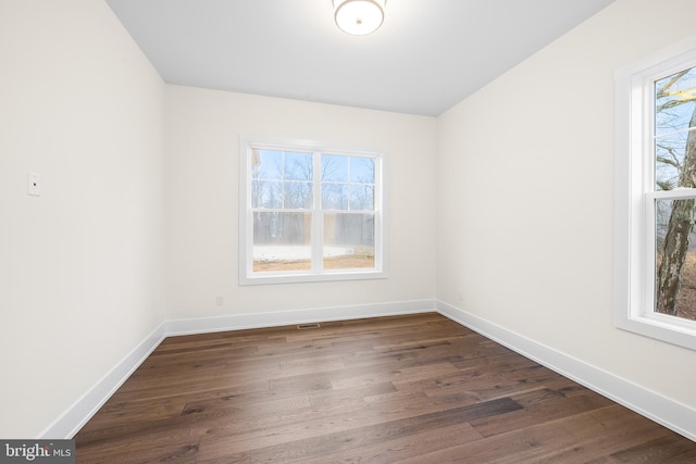 empty room with dark hardwood / wood-style floors