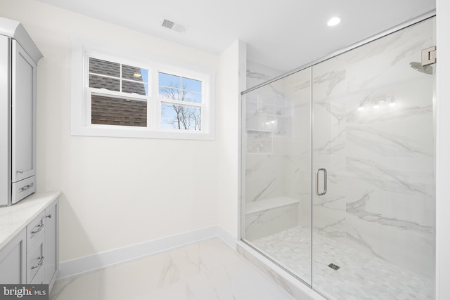 bathroom with vanity and a shower with shower door