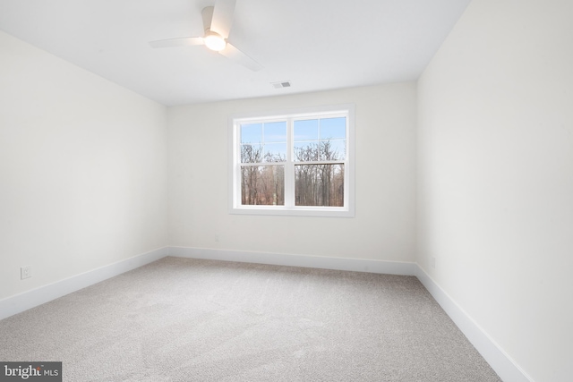 carpeted spare room with ceiling fan