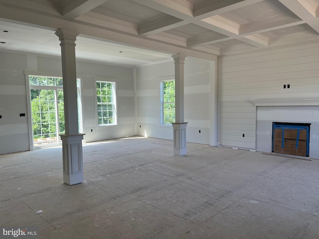 unfurnished living room with beam ceiling, coffered ceiling, decorative columns, and a fireplace