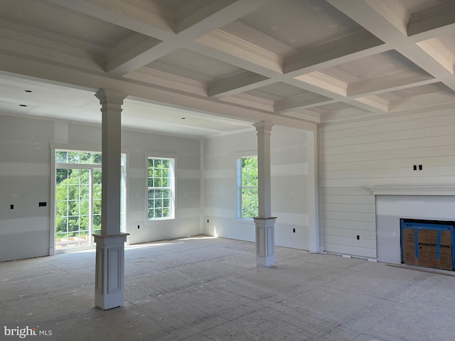 unfurnished living room featuring coffered ceiling, beam ceiling, and ornate columns