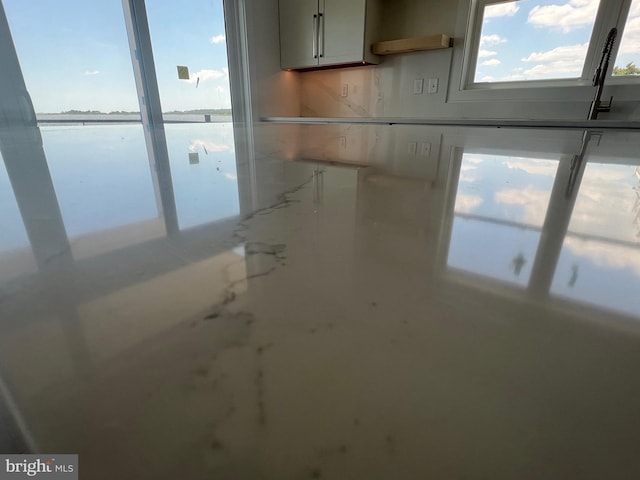 interior space featuring light countertops and a water view