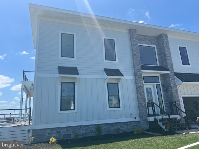 view of front of home with a standing seam roof, metal roof, and board and batten siding