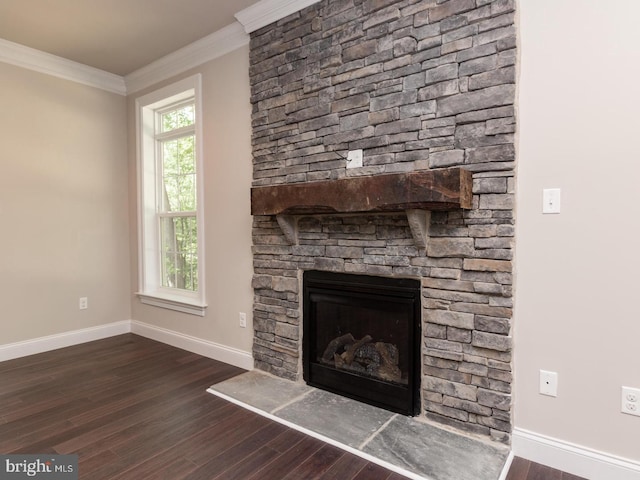 unfurnished living room featuring a fireplace, baseboards, dark wood-type flooring, and crown molding