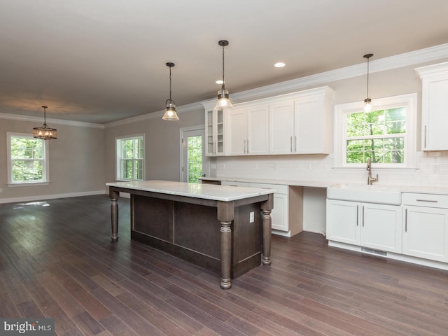 kitchen with glass insert cabinets, white cabinets, and light countertops