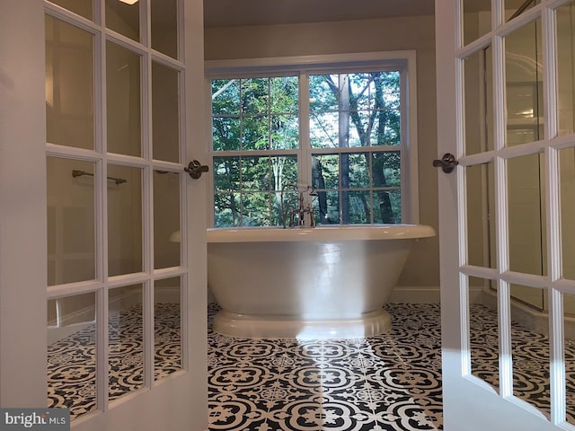 interior space featuring a soaking tub and tile patterned flooring