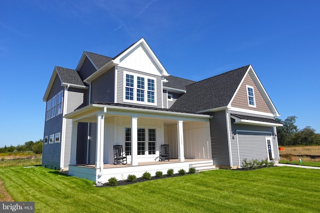 view of front of home with covered porch and a front yard