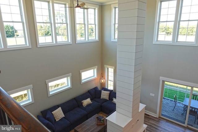 living room with dark hardwood / wood-style floors and crown molding