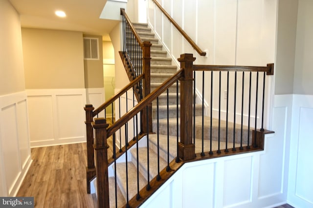 stairs with hardwood / wood-style floors