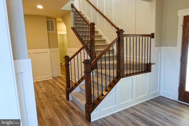 stairway with hardwood / wood-style floors