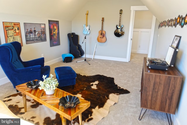 sitting room featuring light carpet and vaulted ceiling