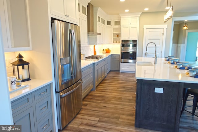 kitchen with white cabinets, decorative light fixtures, sink, and stainless steel appliances