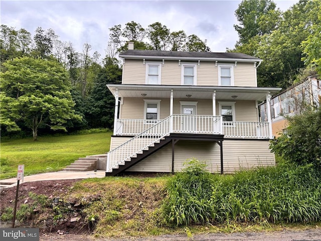 view of front of home with covered porch and a front yard