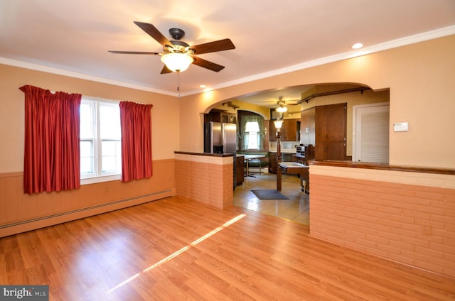 kitchen with kitchen peninsula, stainless steel fridge, baseboard heating, crown molding, and light hardwood / wood-style flooring