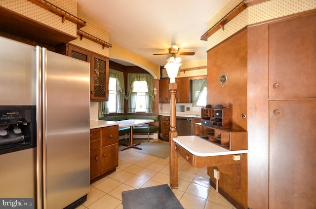 kitchen with stainless steel fridge with ice dispenser, light tile patterned floors, and ceiling fan