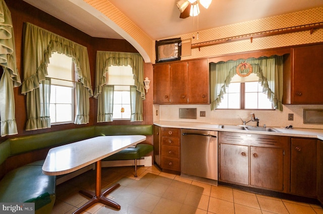 kitchen featuring dishwasher, sink, backsplash, breakfast area, and light tile patterned flooring