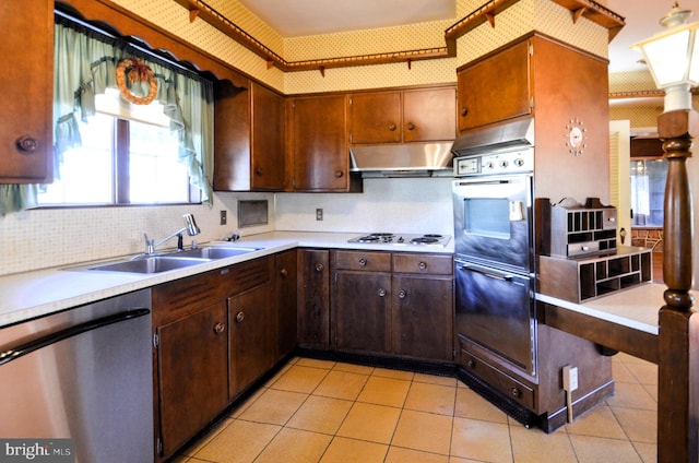 kitchen featuring decorative backsplash, white gas stovetop, sink, dishwasher, and oven